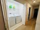 Bright laundry room closet features washer, dryer, shelving, and extra storage space at 1737 Kato Way, Kissimmee, FL 34744