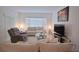 Cozy living room showcasing neutral tones, comfortable seating, and a large window at 1737 Kato Way, Kissimmee, FL 34744