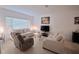 Bright living room with neutral decor, tile floors, and comfortable seating, perfect for relaxation and entertaining at 1737 Kato Way, Kissimmee, FL 34744