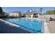 Community pool with clear blue water, lounge chairs, and a clubhouse, perfect for recreation and relaxation at 1737 Kato Way, Kissimmee, FL 34744