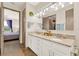 Bathroom featuring double sinks, granite countertop, and wood flooring at 17418 Blazing Star Cir, Clermont, FL 34714