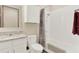 Well-maintained bathroom with a shower-tub combo, granite vanity, and functional cabinet at 17418 Blazing Star Cir, Clermont, FL 34714