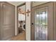 Home entryway featuring an ornate leaded glass door and adjacent access to the laundry room at 17418 Blazing Star Cir, Clermont, FL 34714