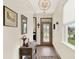 Welcoming foyer with neutral tones, glass front door, console table, and tile flooring at 17418 Blazing Star Cir, Clermont, FL 34714