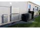 Side view of home showing the installed HVAC and storage battery equipment at 17418 Blazing Star Cir, Clermont, FL 34714