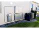 Side view of home showing the installed HVAC, water filter, and storage battery equipment at 17418 Blazing Star Cir, Clermont, FL 34714