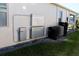 Side view of home showing the installed HVAC and storage battery equipment at 17418 Blazing Star Cir, Clermont, FL 34714