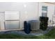 Side view of home showing the installed HVAC, water filter, and storage battery equipment at 17418 Blazing Star Cir, Clermont, FL 34714