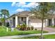 Charming one-story home with a manicured lawn, brick accents, and a welcoming entrance at 17418 Blazing Star Cir, Clermont, FL 34714