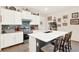Modern kitchen with stainless steel appliances, white cabinets, and a center island with seating at 17418 Blazing Star Cir, Clermont, FL 34714