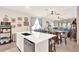 Bright, open kitchen featuring a central island, stainless steel dishwasher, and breakfast bar at 17418 Blazing Star Cir, Clermont, FL 34714