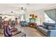 Spacious living room featuring hardwood floors, ceiling fans, fireplace, and comfortable seating at 17418 Blazing Star Cir, Clermont, FL 34714