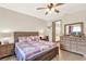 Comfortable main bedroom featuring a ceiling fan, wood flooring, and an ensuite bathroom with double sinks at 17418 Blazing Star Cir, Clermont, FL 34714