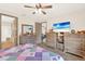 Spacious main bedroom featuring wood flooring, ceiling fan, and access to the ensuite bathroom at 17418 Blazing Star Cir, Clermont, FL 34714