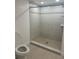 Bathroom featuring decorative tile in shower with glass doors, tile flooring, and a toilet at 1926 Cattleya Dr, Kissimmee, FL 34741