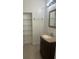 Bathroom with dark vanity, granite countertop, and a built-in glass shelving at 1926 Cattleya Dr, Kissimmee, FL 34741