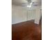 Bedroom featuring laminate wood flooring, ceiling fan, and a closet with mirrored doors at 1926 Cattleya Dr, Kissimmee, FL 34741