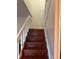 View of staircase with wood stairs and white risers and railing at 1926 Cattleya Dr, Kissimmee, FL 34741