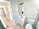 Bathroom featuring new vanity, mirror, lighting, and toilet at 201 4Th Jpv St, Winter Haven, FL 33880