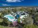 Aerial view of a sunny community featuring a pool and well-manicured landscaping at 204 New Providence # 10104, Davenport, FL 33897