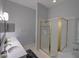 Bright bathroom featuring a double vanity, a walk-in shower with gold trim and natural light at 204 New Providence # 10104, Davenport, FL 33897