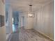 An open-concept dining room featuring a modern chandelier and sleek wood-look floors at 204 New Providence # 10104, Davenport, FL 33897