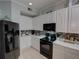 This modern kitchen is equipped with stainless steel appliances and features sleek white cabinets at 204 New Providence # 10104, Davenport, FL 33897