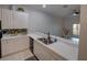 Bright kitchen featuring white cabinets, stainless steel appliances and an open view into the living area at 204 New Providence # 10104, Davenport, FL 33897