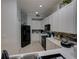 This kitchen is equipped with stainless steel appliances, sleek white cabinets, and tile backsplash at 204 New Providence # 10104, Davenport, FL 33897