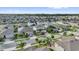 Aerial view of a quiet suburban neighborhood with well-maintained landscaping and palm trees at 2129 Stillwood Way, St Cloud, FL 34771