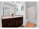 Bathroom featuring a double sink vanity with dark wood cabinets, and a separated shower-tub combo at 2129 Stillwood Way, St Cloud, FL 34771