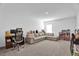 Large bonus room featuring comfortable seating, a desk, and toys creates a versatile living space at 2129 Stillwood Way, St Cloud, FL 34771