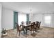 Elegant dining room featuring a chandelier, a large window, and formal dining furniture at 2129 Stillwood Way, St Cloud, FL 34771