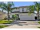 Charming two-story home with a well-manicured lawn and mature palm trees at 2129 Stillwood Way, St Cloud, FL 34771