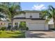 Charming two-story home with a well-manicured lawn and mature palm trees at 2129 Stillwood Way, St Cloud, FL 34771