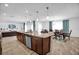 Open-concept kitchen island with granite countertops, connecting to the living and dining areas at 2129 Stillwood Way, St Cloud, FL 34771