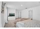 Spacious bedroom with sleek dresser, TV, and minimalist decor creates a serene and modern retreat at 2129 Stillwood Way, St Cloud, FL 34771