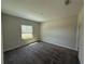 Bedroom with neutral walls, carpet flooring, and a window providing natural light at 220 Brookes Pl, Haines City, FL 33844