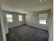 Spacious bedroom featuring carpet flooring and windows that allow natural light at 220 Brookes Pl, Haines City, FL 33844
