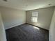 Neutral bedroom with plush carpet, ample natural light, and a window at 220 Brookes Pl, Haines City, FL 33844