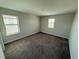 A spacious bedroom with neutral walls and plush carpet, featuring plenty of natural light at 220 Brookes Pl, Haines City, FL 33844