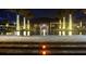 Nighttime view of community pool with lit palm trees and relaxing ambiance at 220 Brookes Pl, Haines City, FL 33844
