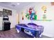 Fun game room with air hockey table and Super Mario Brothers themed wall art at 220 Brookes Pl, Haines City, FL 33844