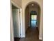 Hallway with arched doorways and tile flooring, leading to the living area at 220 Brookes Pl, Haines City, FL 33844