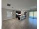 Spacious open kitchen with stainless steel appliances, island, and views of the pool at 220 Brookes Pl, Haines City, FL 33844