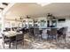 Covered outdoor bar and dining area with ceiling fans and multiple seating options at 220 Brookes Pl, Haines City, FL 33844