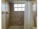 Bathroom featuring bathtub, tiled shower, and white shower curtain at 2494 Sweetwater Club Cir # 55, Kissimmee, FL 34746