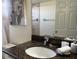Bathroom vanity featuring granite countertop, white sink, and decorative elements at 2494 Sweetwater Club Cir # 55, Kissimmee, FL 34746