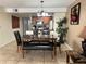 Inviting dining area adjacent to the kitchen featuring a table set with chairs and a bench at 2494 Sweetwater Club Cir # 55, Kissimmee, FL 34746