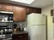 Kitchen featuring stainless steel appliances, wooden cabinets, and updated backsplash with lots of countertop space at 2494 Sweetwater Club Cir # 55, Kissimmee, FL 34746